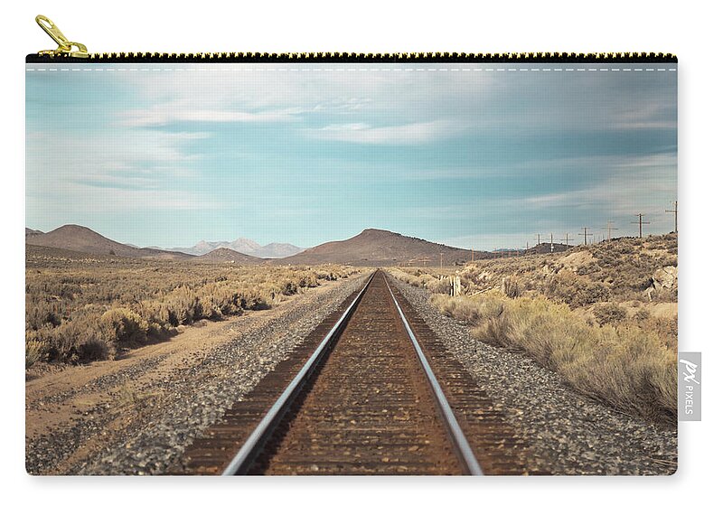 Tranquility Zip Pouch featuring the photograph Train Tracks In The Desert by Harpazo hope