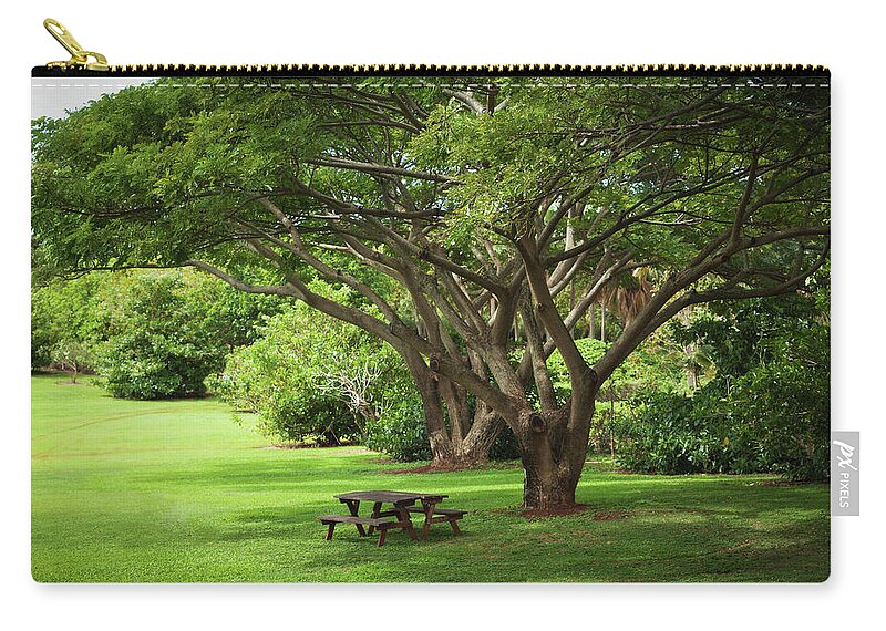 Flowerbed Zip Pouch featuring the photograph Tropical Garden With Picnic Benches by Yinyang