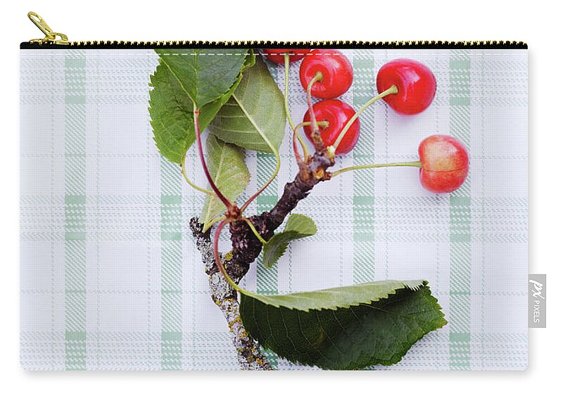 Cherry Zip Pouch featuring the photograph Twig With Leaves And Cherries by Johner Images