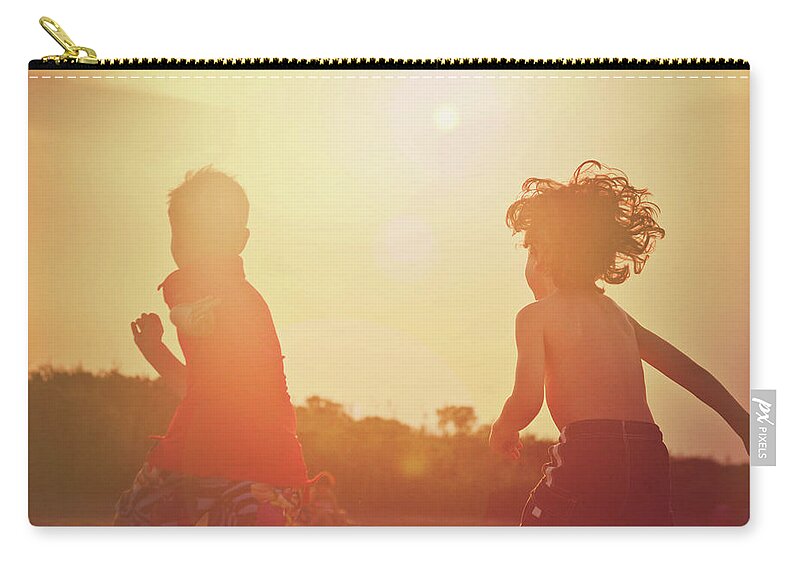 Child Zip Pouch featuring the photograph Two Young Boys Running On The Beach At by Fran Polito