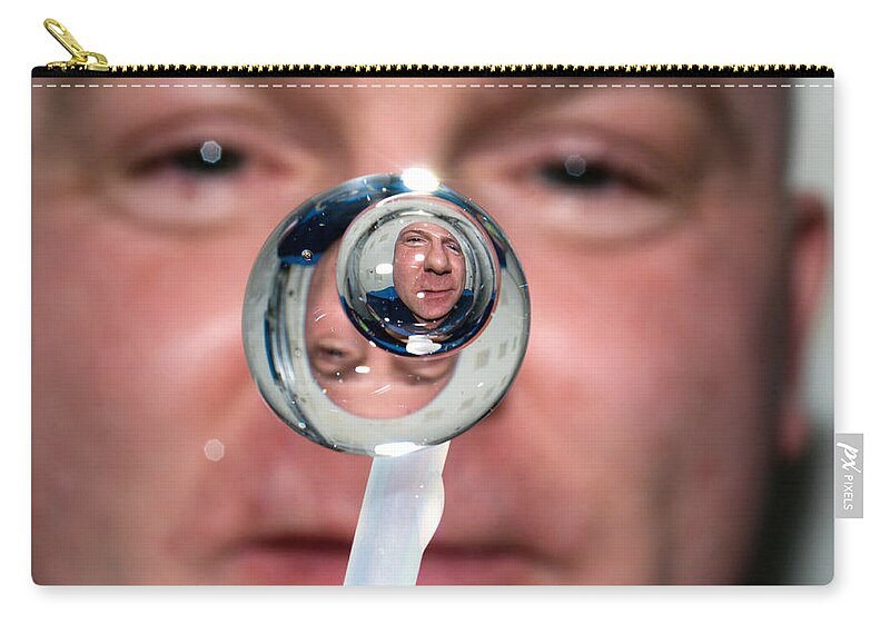 Space Zip Pouch featuring the photograph Water Droplet On The Iss by Science Source
