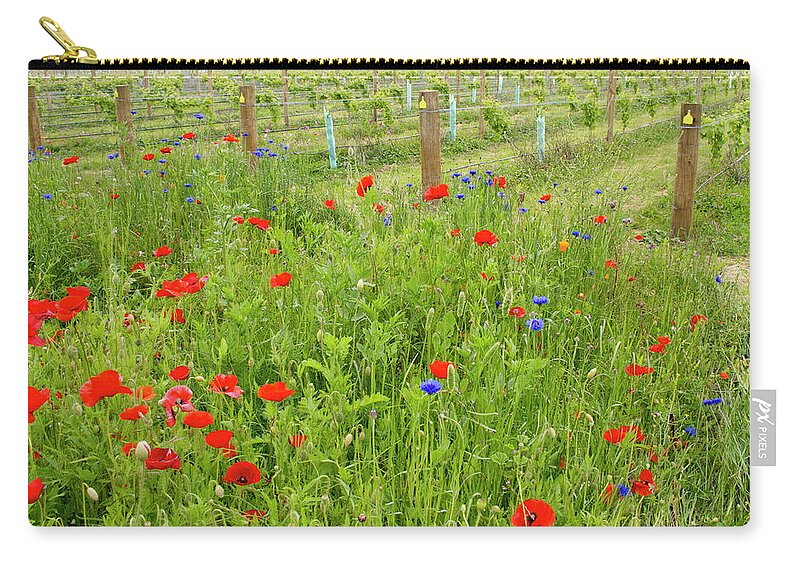 Scenics Zip Pouch featuring the photograph Wild Flowers Along The Edge Of A by Lazingbee