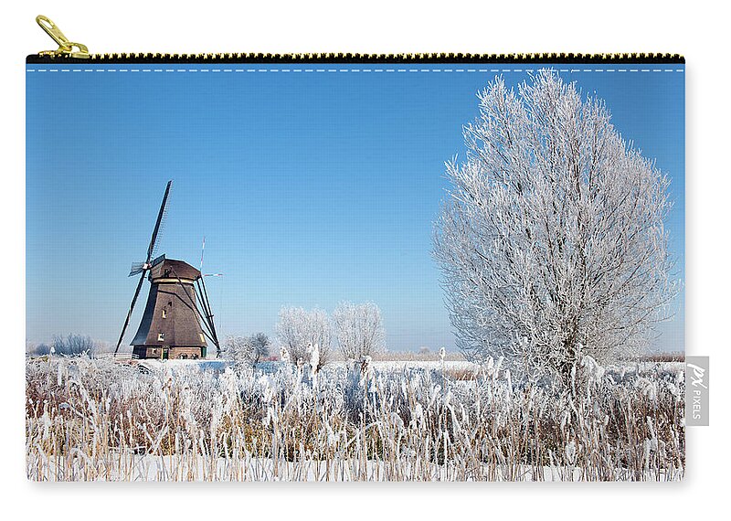 Scenics Zip Pouch featuring the photograph Windmill At Kinderdijk In Wintry by Pidjoe