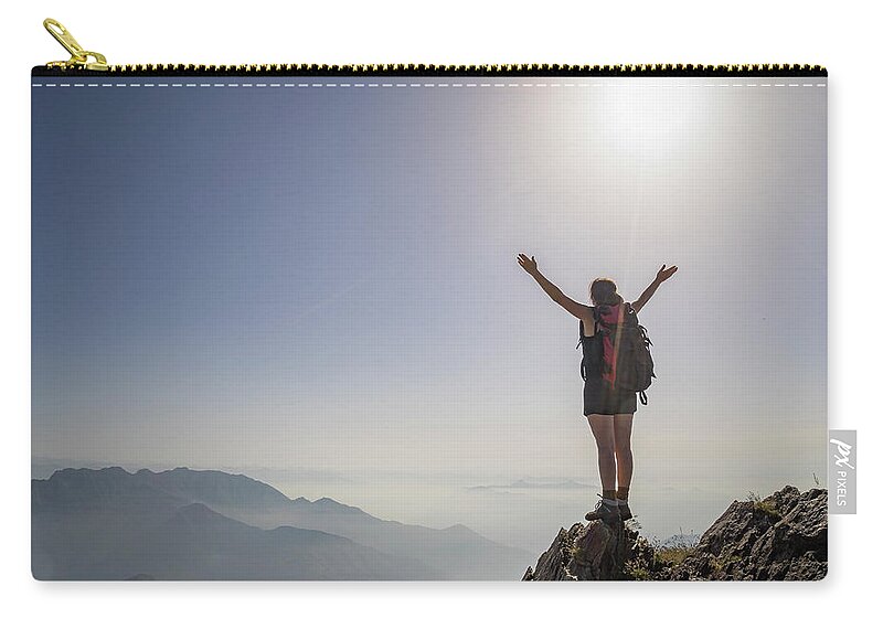 People Zip Pouch featuring the photograph Woman Exulting On A Mountaintop by Buena Vista Images