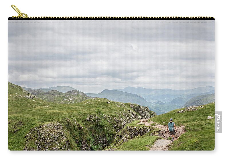Scenics Zip Pouch featuring the photograph Woman Hiking In Lake District by David Madison