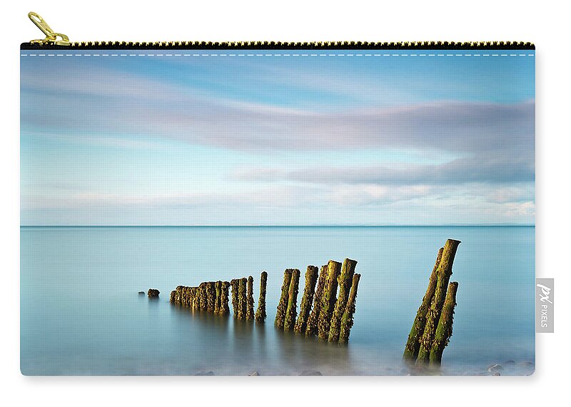Scenics Zip Pouch featuring the photograph Wooden Groynes On A Beach At Low Tide by Jeremy Walker