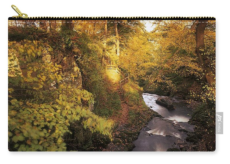 Autumn Zip Pouch featuring the photograph Flowing Water Through A Forest by The Irish Image Collection 