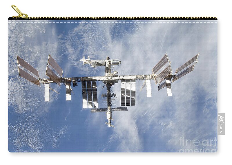 Sts-128 Zip Pouch featuring the photograph International Space Station Backdropped by Stocktrek Images
