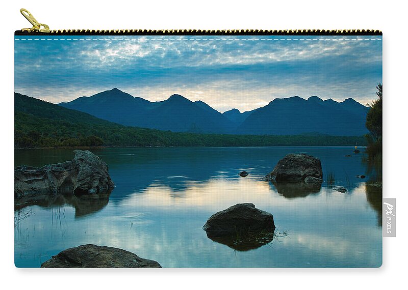 Alpine Zip Pouch featuring the photograph Sheep clouds above a lake by U Schade