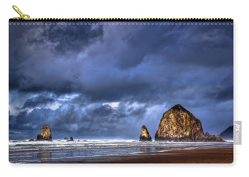 Cannon Beach Zip Pouch featuring the photograph Stormy Clouds in Cannon Beach by Niels Nielsen