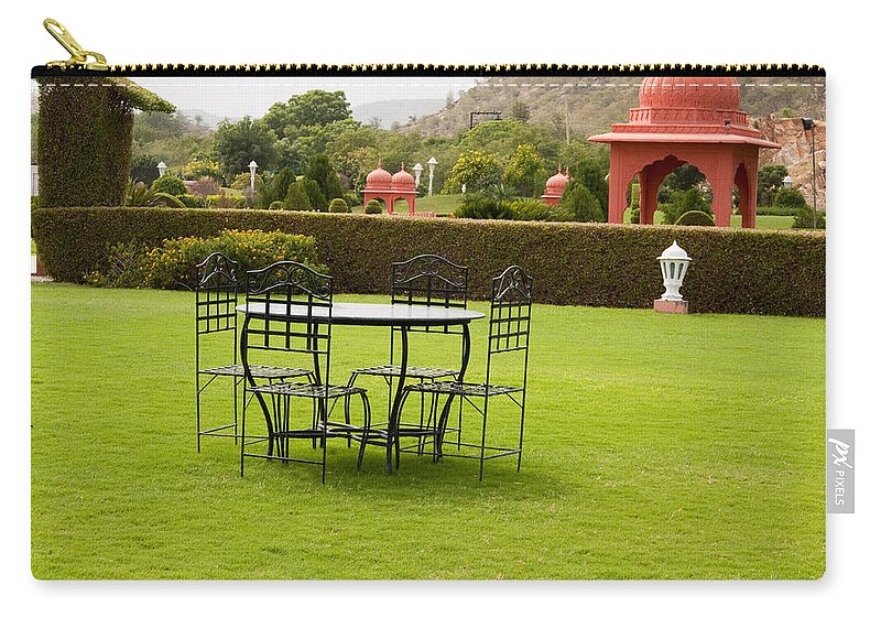 India Zip Pouch featuring the photograph Wrought metal chairs around a table in a lawn by Ashish Agarwal