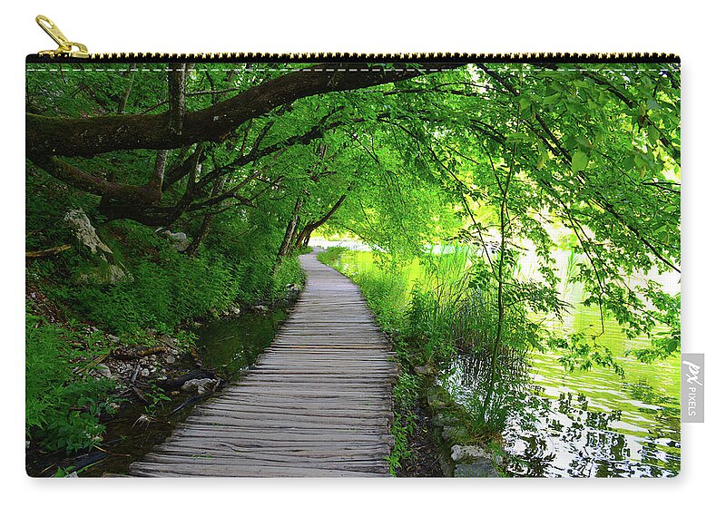 Green Zip Pouch featuring the photograph Hiking Path in Plitvice National Park Croatia #1 by Brandon Bourdages
