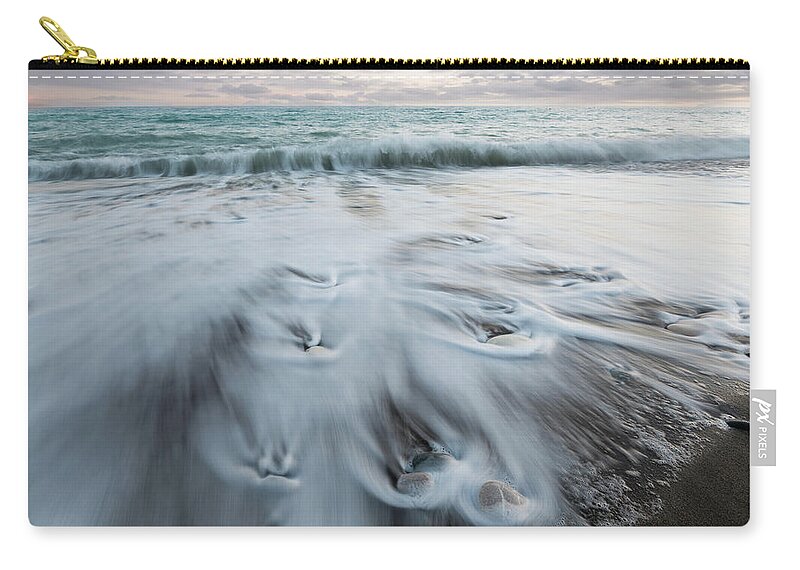 Coastline Carry-all Pouch featuring the photograph Pebbles in the beach and flowing sea water by Michalakis Ppalis