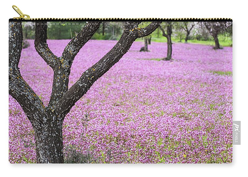 Spring Zip Pouch featuring the photograph Spring landscape. Almond tree and purple flower field by Michalakis Ppalis