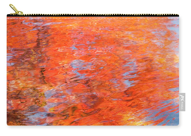 Autumn Zip Pouch featuring the photograph Colors reflecting in a pond becomes a wash of color. by Usha Peddamatham