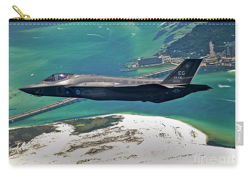 Stealth Carry-all Pouch featuring the photograph An F-35 Lightning II Flies Over Destin by Stocktrek Images