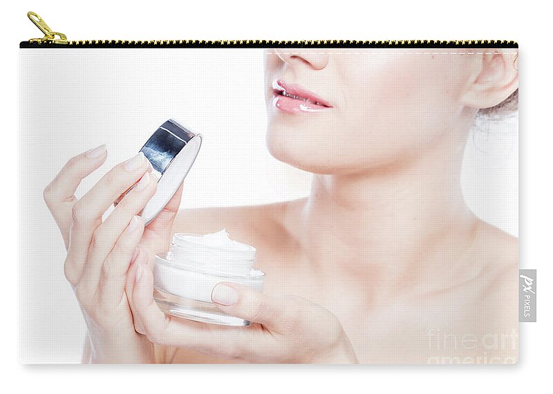 Skincare Zip Pouch featuring the photograph Attractive woman opening a face cream. by Michal Bednarek