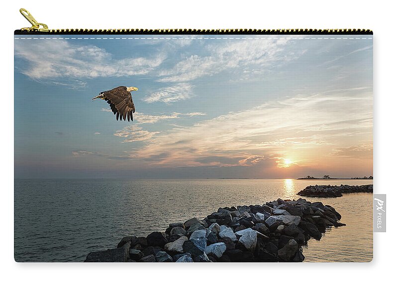 Bald Eagle Zip Pouch featuring the photograph Bald Eagle flying over a jetty at sunset by Patrick Wolf