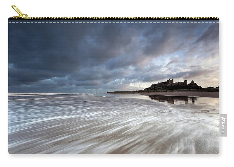 Bamburgh Castle Zip Pouch featuring the photograph Bamburgh Castle at high tide in the surf by Anita Nicholson