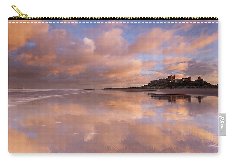 Bamburgh Castle Carry-all Pouch featuring the photograph Bamburgh Castle sunset reflections on the beach by Anita Nicholson