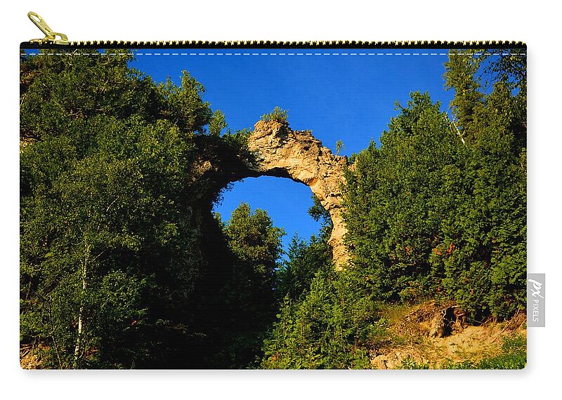 Mackinac Island Zip Pouch featuring the photograph Beneath Arch Rock by Keith Stokes