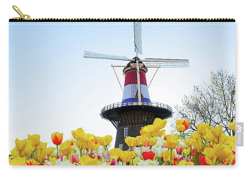 Amsterdam Zip Pouch featuring the photograph Dutch Windmill with Netherlands Flag by Anastasy Yarmolovich