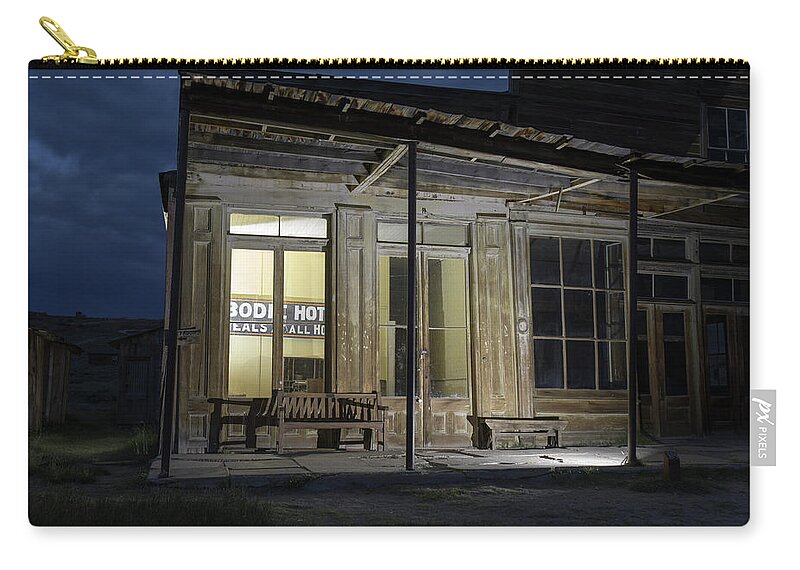 Abandoned Zip Pouch featuring the photograph Bodie Hotel illuminated at night by Karen Foley