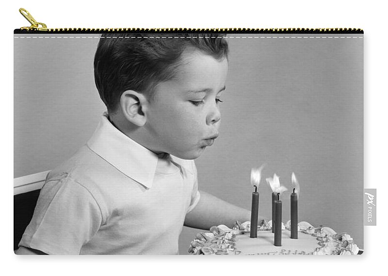 1950s Zip Pouch featuring the photograph Boy Blowing Out Candles On Cake, C.1950s by H. Armstrong Roberts/ClassicStock