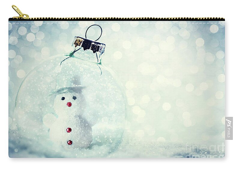 Christmas Zip Pouch featuring the photograph Christmas glass ball with snowman inside. Snow and glitter by Michal Bednarek