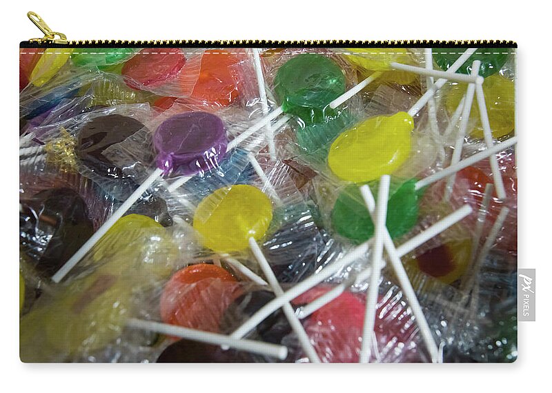 Candies Zip Pouch featuring the photograph Colorful fruit lollipops by Karen Foley