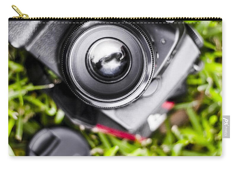 Photography Zip Pouch featuring the photograph Digital SLR camera on green grassy field by Jorgo Photography