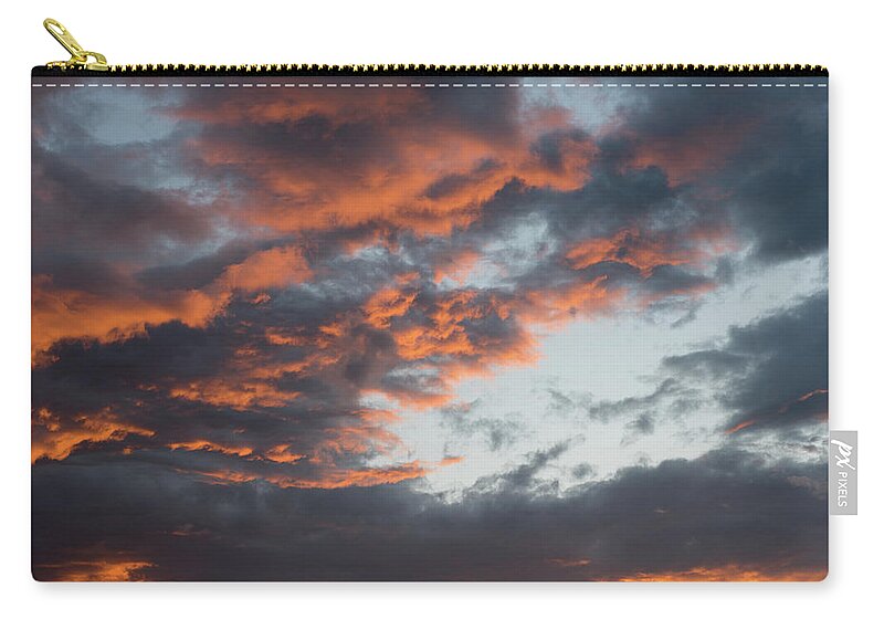 Stormy Clouds Carry-all Pouch featuring the photograph Dramatic sunset sky with orange cloud colors by Michalakis Ppalis