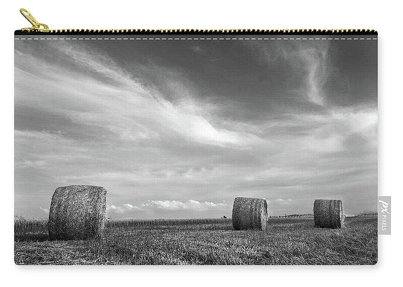 Agriculture Zip Pouch featuring the photograph Field of Round bales of hay after harvesting by Michalakis Ppalis