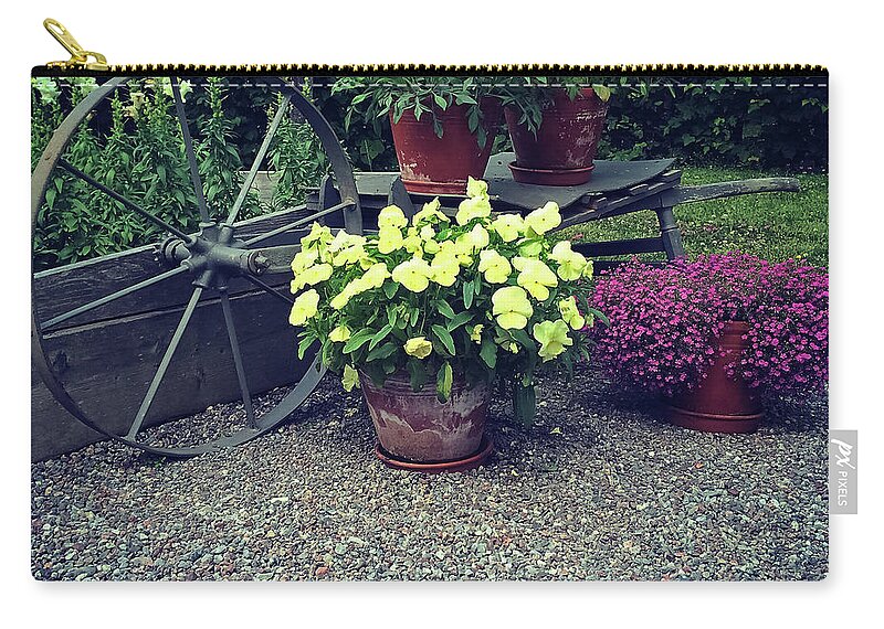 Flowers Zip Pouch featuring the photograph Garden decorated with flowers and old wheel by GoodMood Art