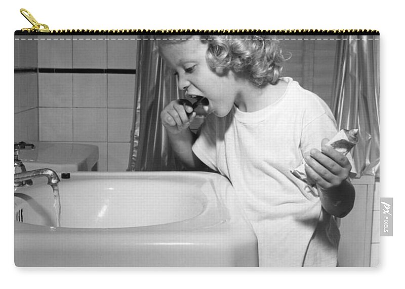 1950s Zip Pouch featuring the photograph Girl Brushing Her Teeth, C.1950s by E. Hibbs/ClassicStock