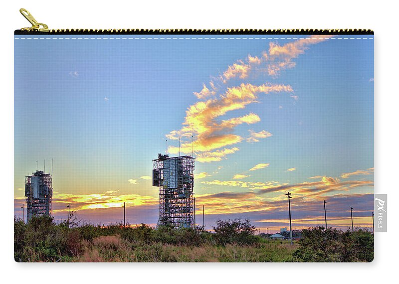 16485 Zip Pouch featuring the photograph Launch Complex 17 at Sunset by Gordon Elwell