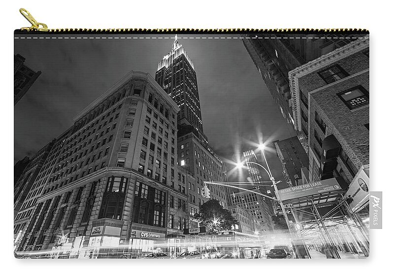 New.york Zip Pouch featuring the photograph Looking up at the Empire State building from Fifth Avenue at night New York NY Black and White by Toby McGuire