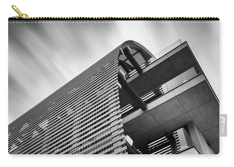 Skyscraper Zip Pouch featuring the photograph Modern futuristic design skyscraper building and moving clouds by Michalakis Ppalis