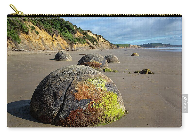 New Zealand Zip Pouch featuring the photograph Moeraki Boulders by Cheryl Strahl