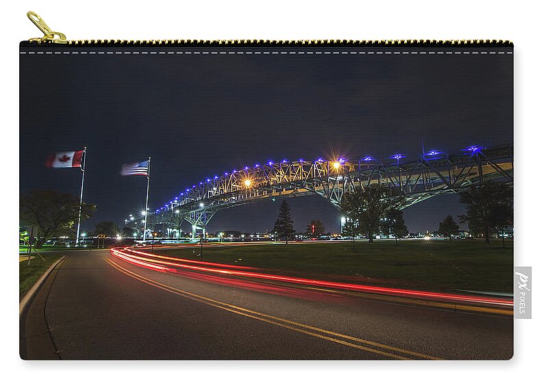 Port Huron Zip Pouch featuring the photograph Nightly Neighbors at the Blue Water Bridge by Jay Smith
