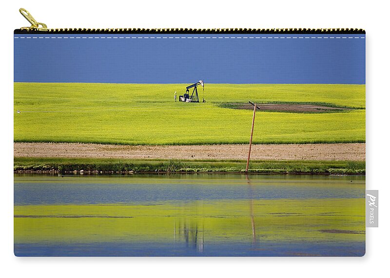 Industry Zip Pouch featuring the photograph Oil Jack Reflection Saskatchewan by Mark Duffy