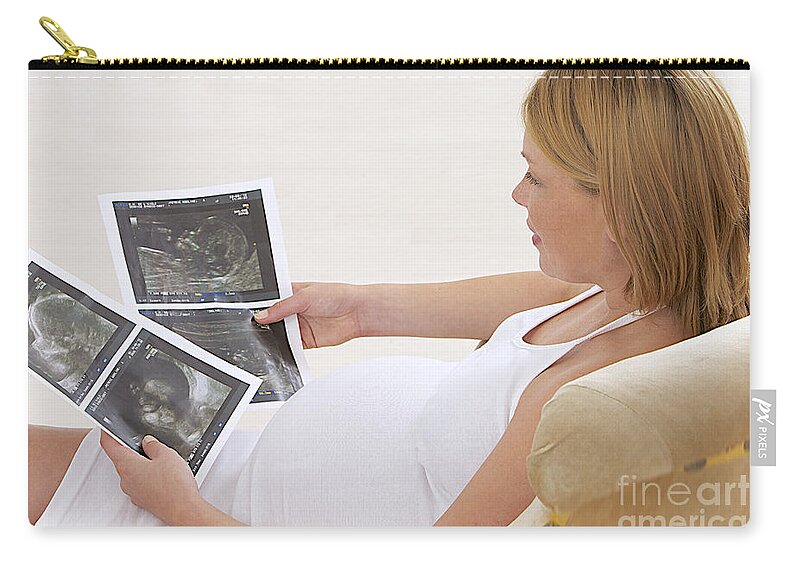 Examination Zip Pouch featuring the photograph Pregnant Woman Looks At Ultrasonounds by Jean-Paul Chassenet
