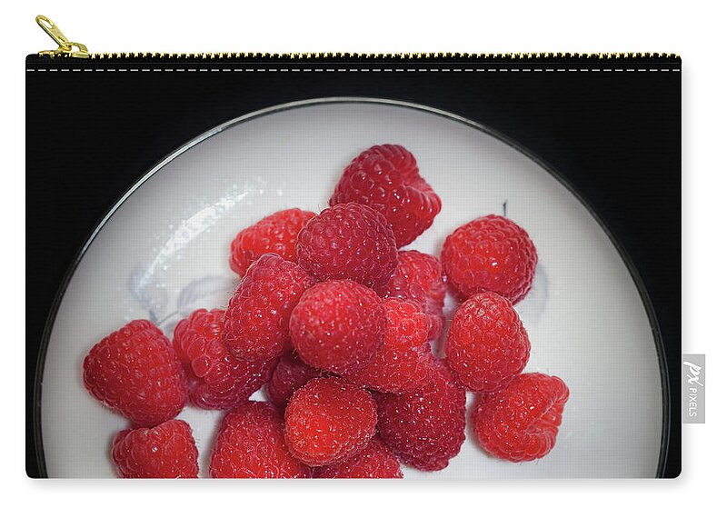 Berries Zip Pouch featuring the photograph Raspberries on a plate with violet flower by Alexander Fedin