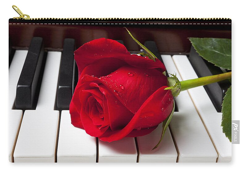 Red Rose Roses Zip Pouch featuring the photograph Red rose on piano keys by Garry Gay