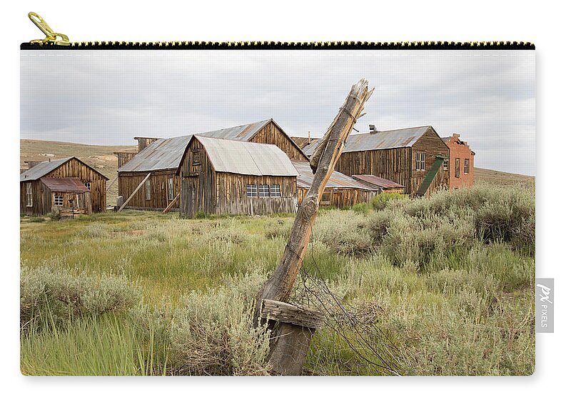 Abandoned Zip Pouch featuring the photograph Rustic wooden structures in Bodie, California by Karen Foley
