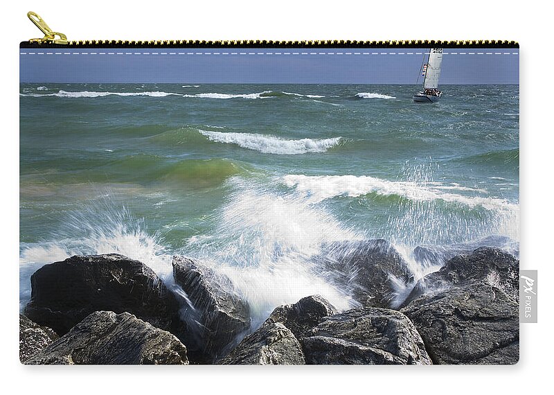 Lake Zip Pouch featuring the photograph Sailboat sailing off the shore at Ottawa Beach State Park by Randall Nyhof