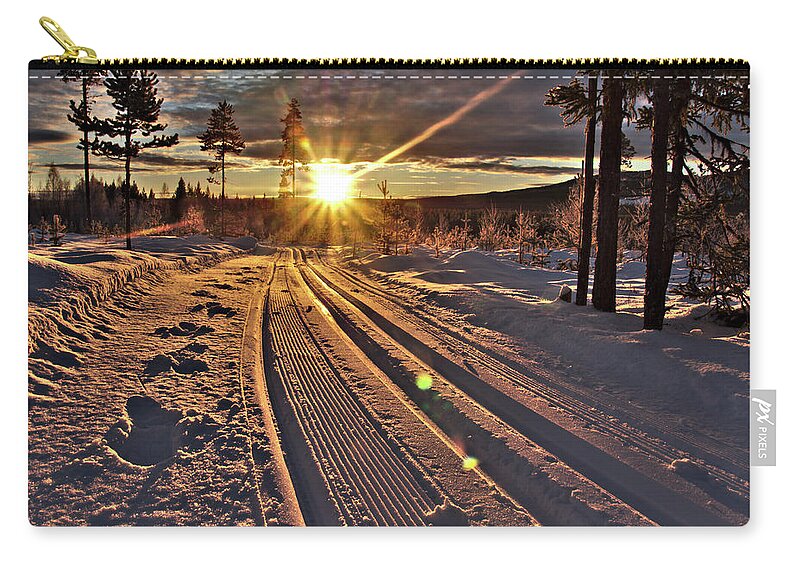 Ski Trails With Sun Beams By Sushko Zip Pouch featuring the photograph Ski trails with sun beams by Tamara Sushko