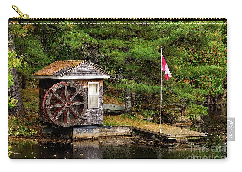 Colors Zip Pouch featuring the photograph Small shed with a large wooden wheel by Les Palenik