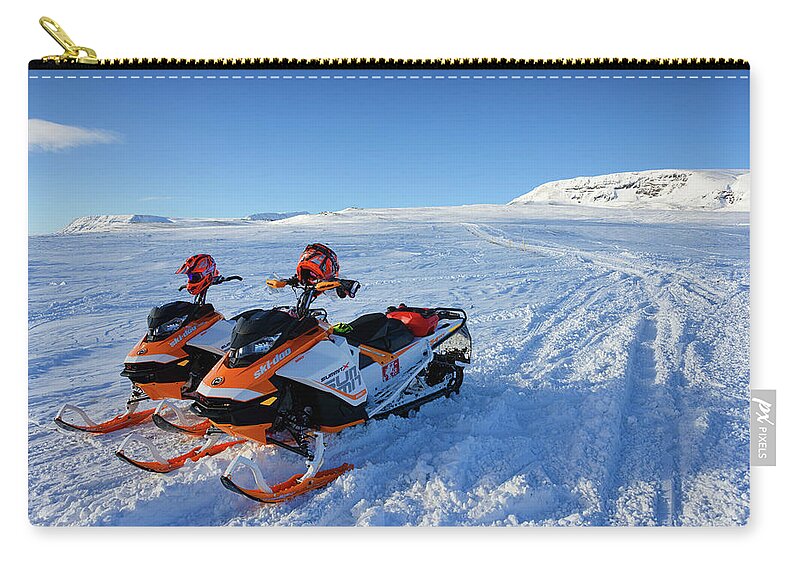 Snowmobile Zip Pouch featuring the photograph Snowmobiles in Iceland in winter by Matthias Hauser