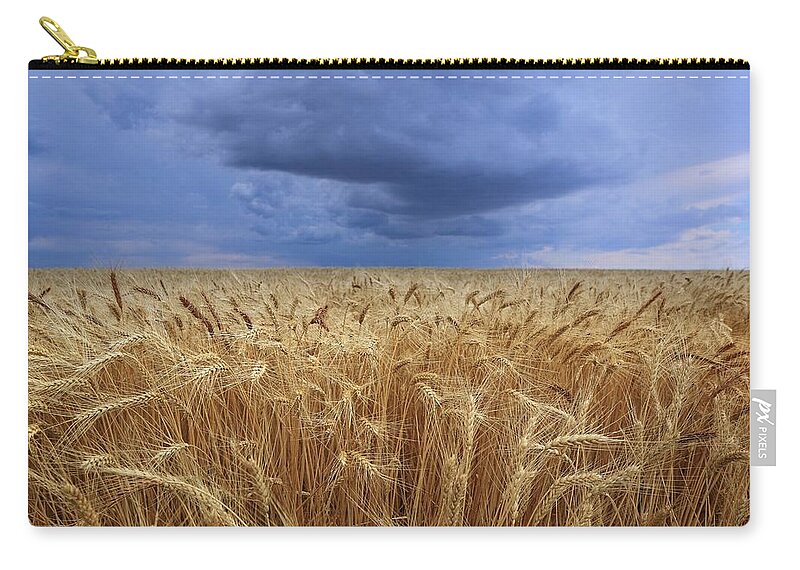 Stormy Wheat Field Zip Pouch featuring the photograph Stormy wheat field by Lynn Hopwood